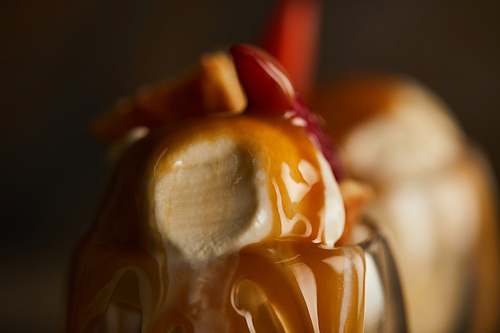 close up view of delicious ice cream scoop with caramel