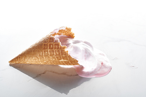 delicious ice cream in waffle cone on marble grey background