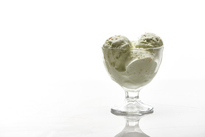 delicious pistachio ice cream in glass bowl isolated on white