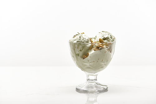 delicious pistachio ice cream with nuts isolated on white