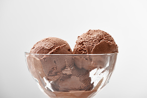 close up view of delicious chocolate ice cream in glass bowl isolated on grey