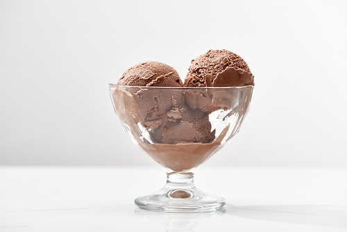 delicious chocolate ice cream in glass bowl isolated on grey