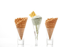 fresh crispy sweet waffle cones and pistachio ice cream isolated on white