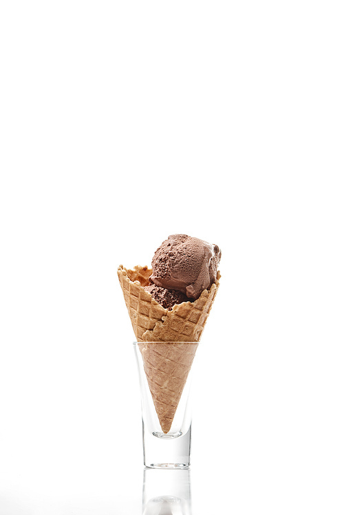 delicious sweet chocolate ice cream in crispy waffle cone isolated on white