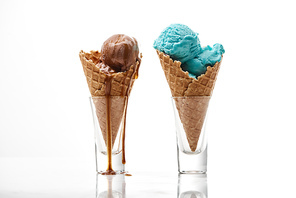 delicious sweet chocolate and blue ice cream in crispy waffle cones isolated on white