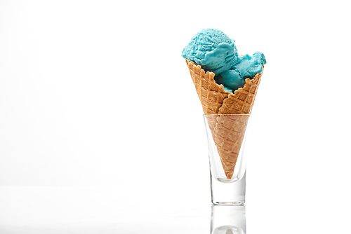 delicious sweet blue ice cream in crispy waffle cone isolated on white