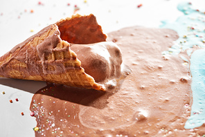 close up view of delicious melted chocolate ice cream in waffle cone