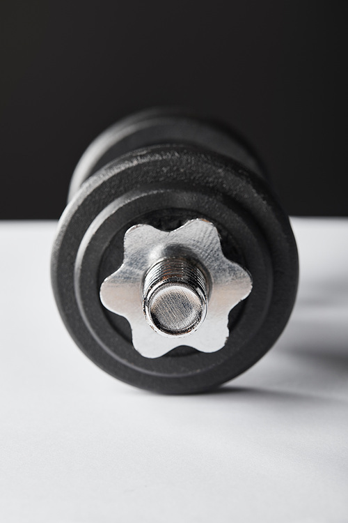 selective focus of heavy dumbbell on black