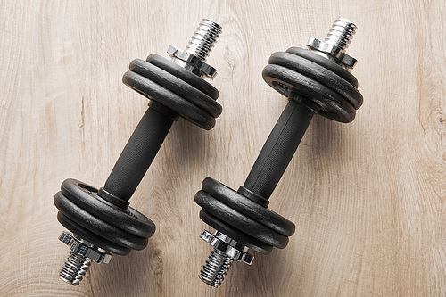 top view of heavy dumbbells on wooden surface