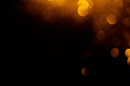 golden bokeh on black background with copy space