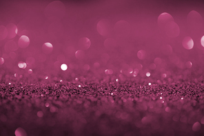 abstract background with purple glitter and bokeh