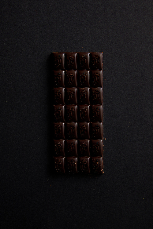top view of gourmet bar of chocolate isolated on black