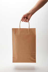 cropped image of woman holding paper bag with food delivery on white