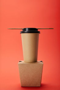 arranged noodle box| paper cup of coffee with chopsticks on red| minimalistic concept