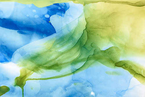 beautiful green and blue splashes of alcohol inks as abstract backdrop