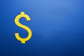 elevated view of yellow dollar sign on blue background