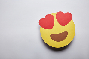 elevated view of in love emoticon on grey background