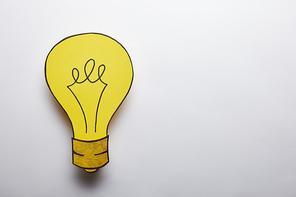 top view of yellow light bulb idea symbol on grey background