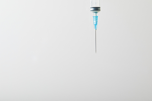 close up of syringe for injection isolated on grey with copy space