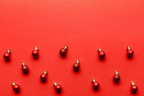 shiny festive christmas baubles on red background