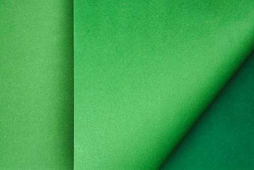 top view of green paper on colored background