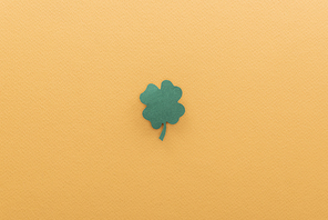 top view of shamrock isolated on orange with copy space| st patrick day concept