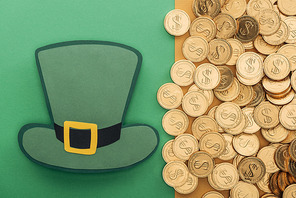 top view of golden coins with dollar signs and paper hat on green and orange background| st patrick day concept