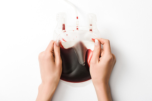 Partial view of woman holding drip with blood on white background| blood donation concept