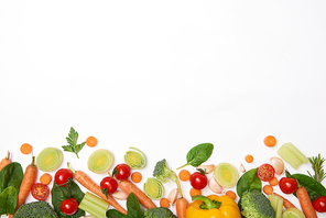 Top view of spinach leaves and vegetables on white background