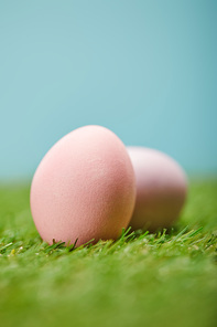 selective focus of easter painted eggs on grass