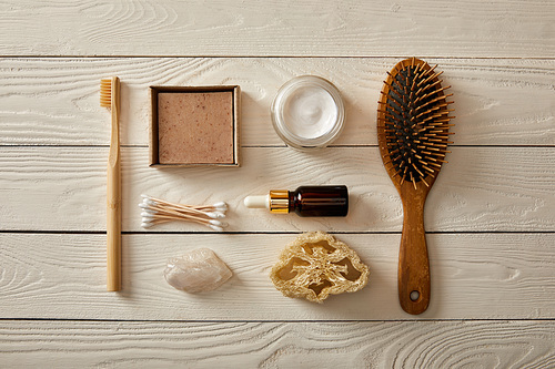 top view of various hygiene and cosmetic items on white wooden surface| zero waste concept