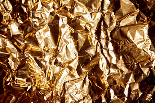 crumpled golden foil with shadows and twinkles