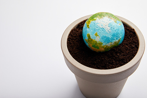 planet model placed on flowerpot with soil| earth day concept