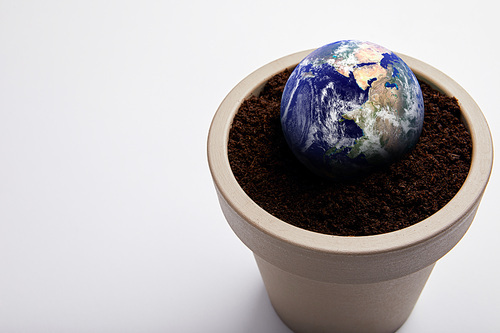 planet model placed on flowerpot with soil| earth day concept