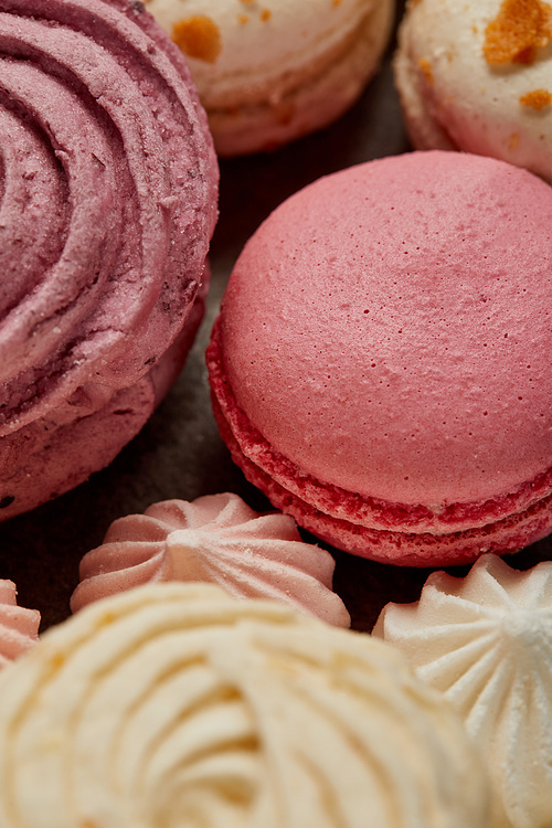Delicious pink french macaron with soft zephyr and small pink meringues