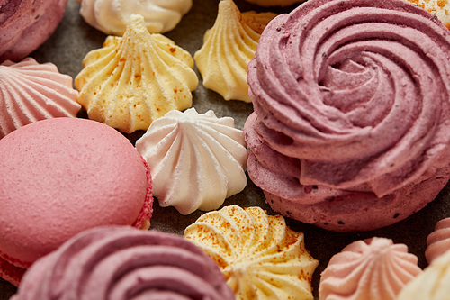 Small sweet meringues with pink soft zephyr and pink french macaroons