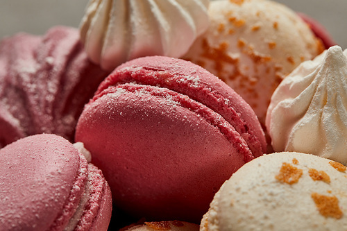 Delicious white macaroons sprinkled with chopped caramel with pink macaroons ans meringues