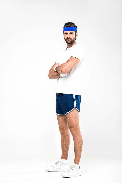 handsome sportsman in retro sportswear with crossed arms, isolated on white