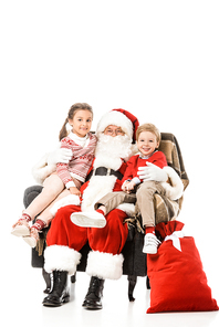 happy kids and santaembracing and  while sitting in armchair together isolated on white