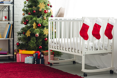 interior of christmas decorated baby room with infant bed
