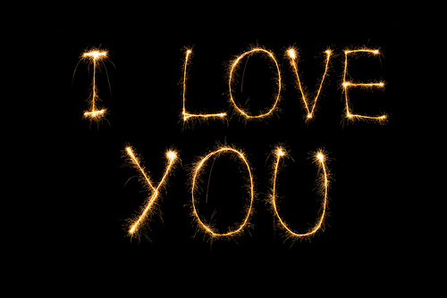 close up view of i love you light lettering on black background, st valentines day concept