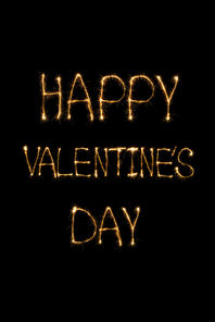 close up view of happy valentines day light lettering on black background, st valentines day concept