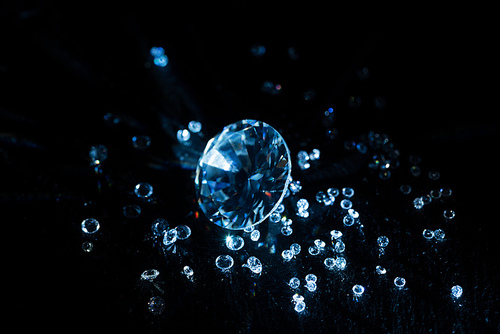 big and small transparent clear diamonds isolated on black