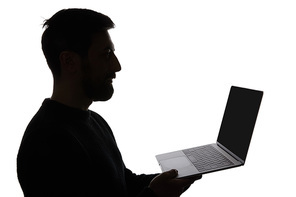 Silhouette of man holding laptop with blank screen isolated on white