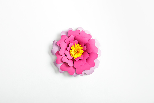 top view of pink and lilac paper flower on grey background
