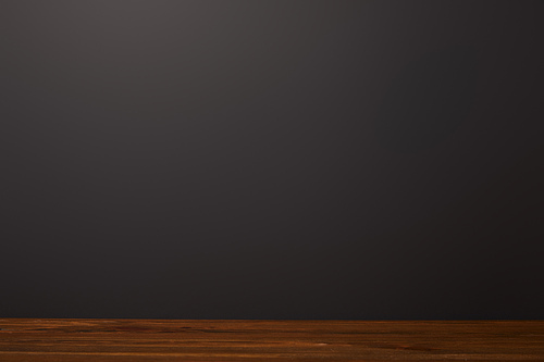 wooden surface near black background with copy space