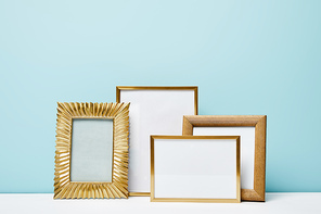 blank square decorative frames near blue wall