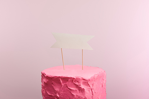 pink sweet birthday cake with blank card isolated on pink