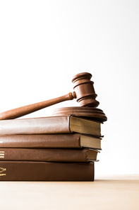 bottom view of gavel on pile of brown books on wooden table isolated on white