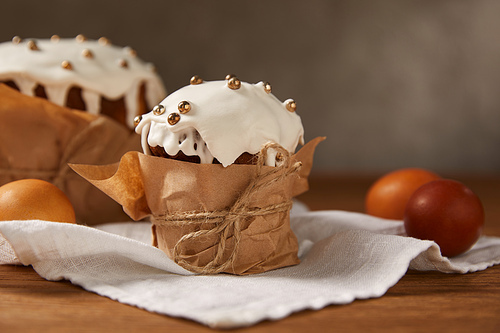 painted chicken eggs and delicious . cakes decorated with frosting and sprinkles on napkin